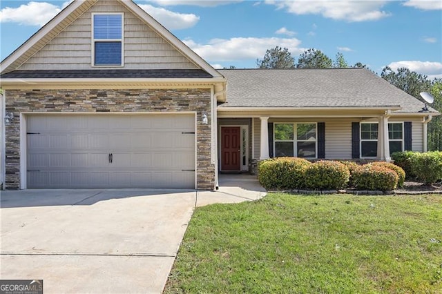 view of front facade with a shingled roof, an attached garage, a front lawn, stone siding, and driveway