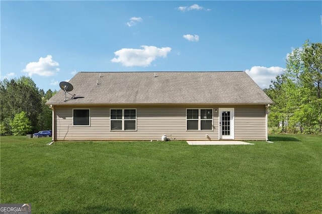 back of property featuring a yard and a patio