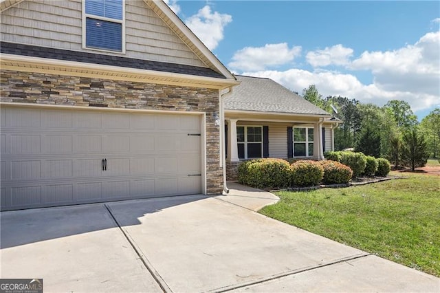 view of front of house with concrete driveway, stone siding, and a front lawn