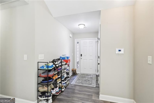 entryway with baseboards and dark wood finished floors