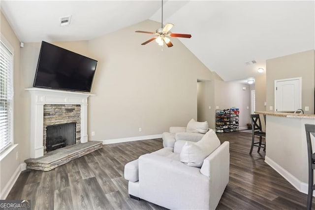 living area with high vaulted ceiling, a wealth of natural light, a ceiling fan, and visible vents