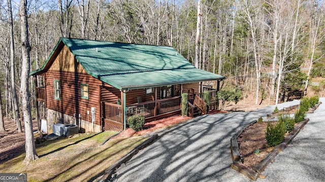 30 The Forest Rd, Blue Ridge, GA 30513 - view of front of property with faux log siding, a view of trees, metal roof, and covered porch