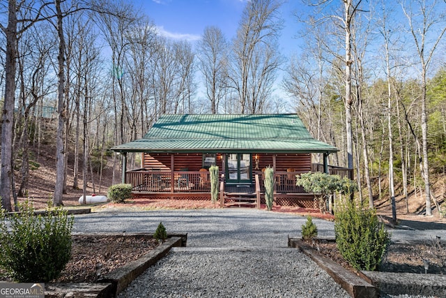30 The Forest Rd, Blue Ridge, GA 30513 - view of front of home featuring driveway, covered porch, and metal roof