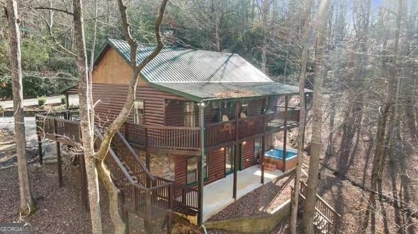 30 The Forest Rd, Blue Ridge, GA 30513 - view of side of property with a patio area, log veneer siding, metal roof, and a deck