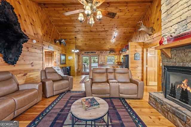 30 The Forest Rd, Blue Ridge, GA 30513 - living area featuring a fireplace, light wood-type flooring, wood walls, and a ceiling fan