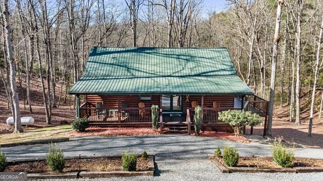 30 The Forest Rd, Blue Ridge, GA 30513 - log cabin with a porch, log siding, a wooded view, and metal roof