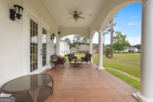 view of patio featuring a residential view, ceiling fan, and french doors