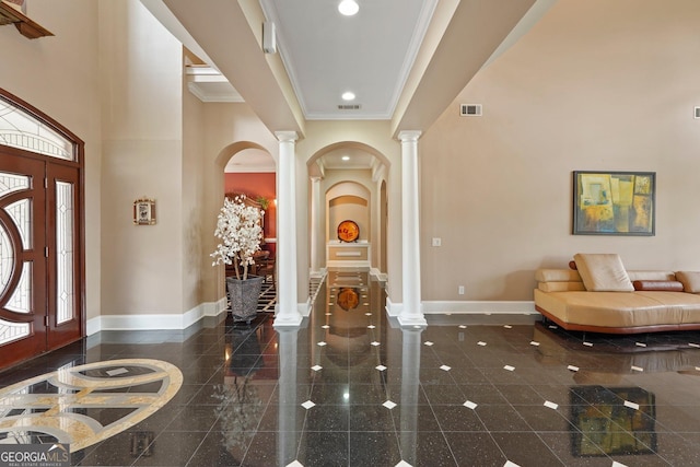 foyer featuring baseboards, ornate columns, and granite finish floor