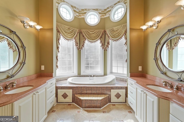 full bath featuring a garden tub, a towering ceiling, two vanities, and a sink