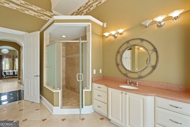 bathroom featuring tile patterned floors, a shower stall, vanity, and baseboards