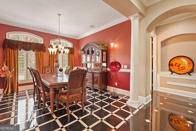 dining area featuring baseboards, ornamental molding, a notable chandelier, and arched walkways