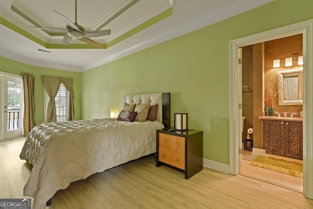 bedroom with ensuite bath, crown molding, access to exterior, visible vents, and wood finished floors