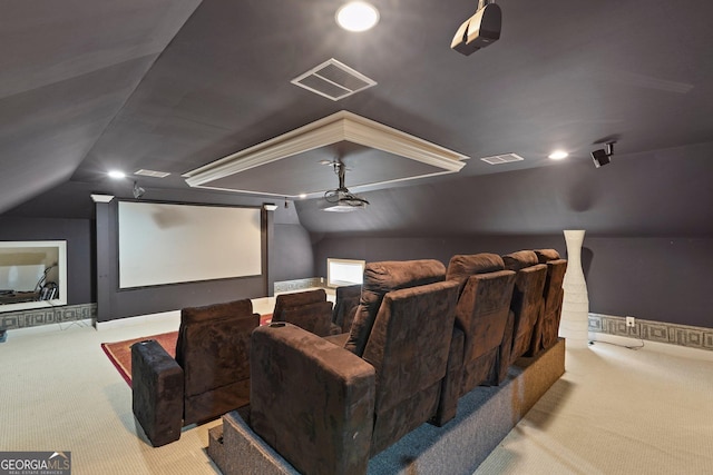 carpeted cinema room with visible vents and vaulted ceiling