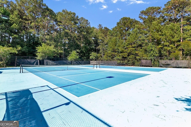 view of tennis court featuring fence