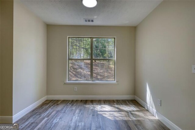 479 Lakeview Dr, Dahlonega, GA 30533 - unfurnished room with wood finished floors, visible vents, and baseboards