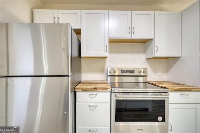 479 Lakeview Dr, Dahlonega, GA 30533 - kitchen featuring appliances with stainless steel finishes, wooden counters, and white cabinetry