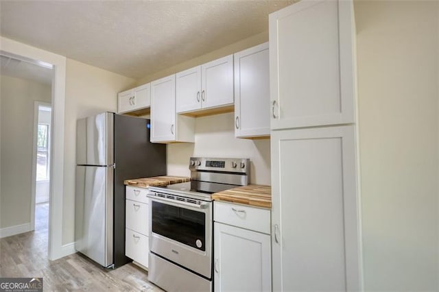 479 Lakeview Dr, Dahlonega, GA 30533 - kitchen featuring wooden counters, light wood-type flooring, white cabinetry, baseboards, and appliances with stainless steel finishes