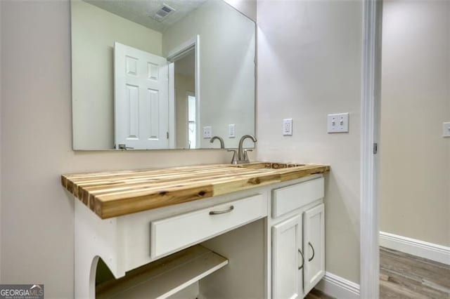 479 Lakeview Dr, Dahlonega, GA 30533 - bathroom featuring baseboards, wood finished floors, visible vents, and vanity
