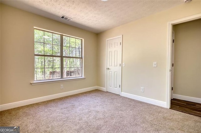 479 Lakeview Dr, Dahlonega, GA 30533 - unfurnished bedroom featuring a textured ceiling, carpet floors, visible vents, and multiple windows