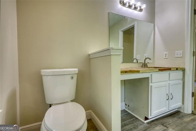 479 Lakeview Dr, Dahlonega, GA 30533 - bathroom featuring baseboards, wood finished floors, toilet, and vanity