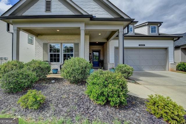 view of front facade featuring an attached garage, concrete driveway, and brick siding