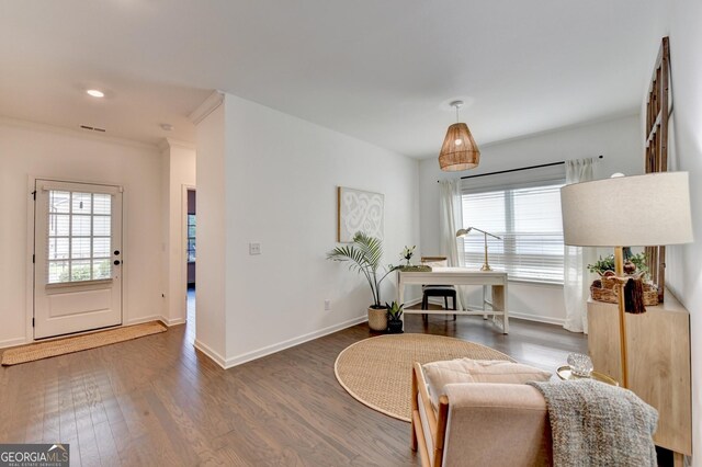 sitting room featuring wood finished floors, baseboards, ornamental molding, and recessed lighting