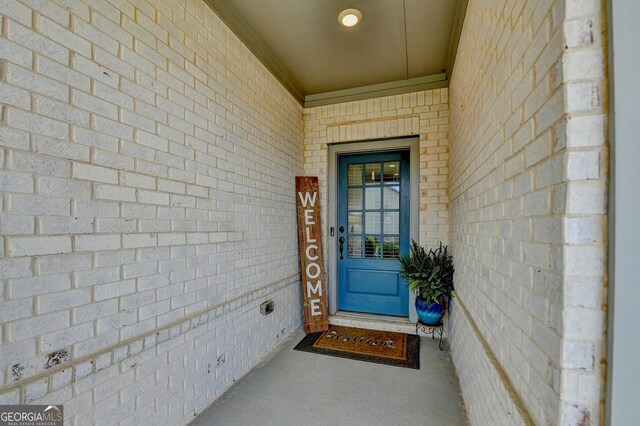 entrance to property with brick siding