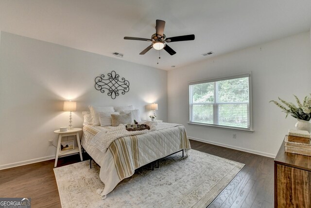 bedroom with baseboards, dark wood-style floors, and a ceiling fan