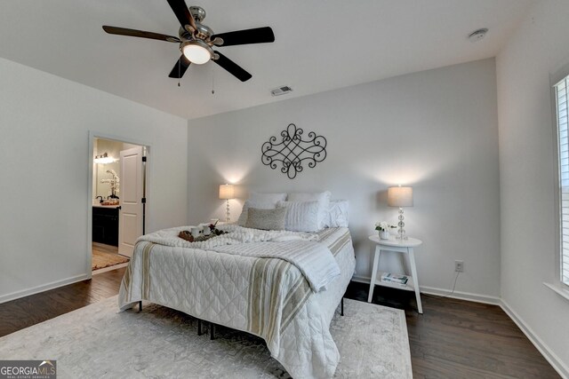 bedroom with wood finished floors, multiple windows, baseboards, and ceiling fan