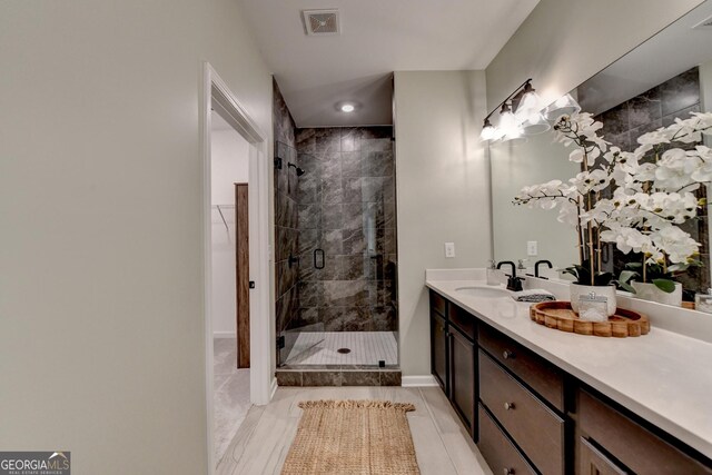 full bathroom featuring a stall shower, vanity, baseboards, and recessed lighting