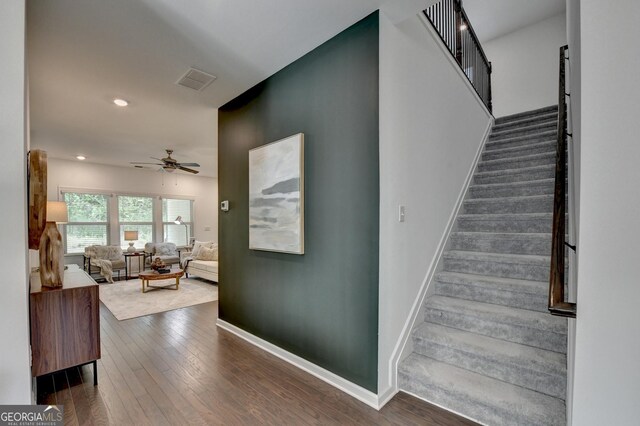 stairway featuring ceiling fan, baseboards, hardwood / wood-style flooring, and recessed lighting