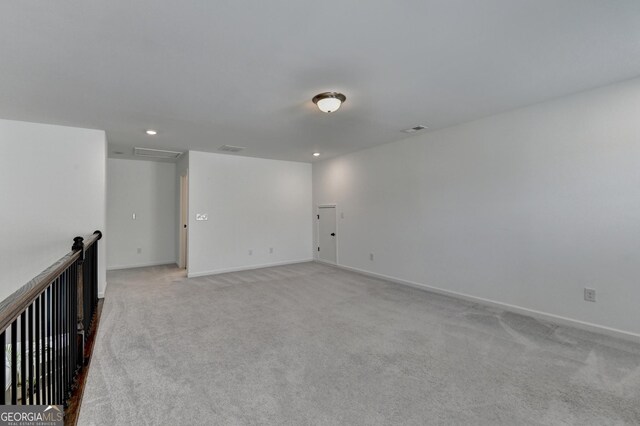 unfurnished room featuring light colored carpet, recessed lighting, and baseboards