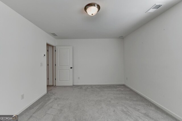 carpeted spare room with baseboards