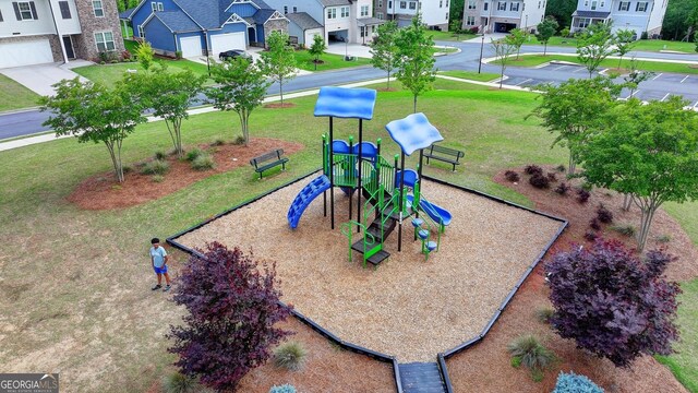 community jungle gym with a residential view and a yard