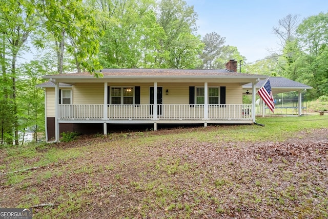 view of front of house with covered porch and a chimney