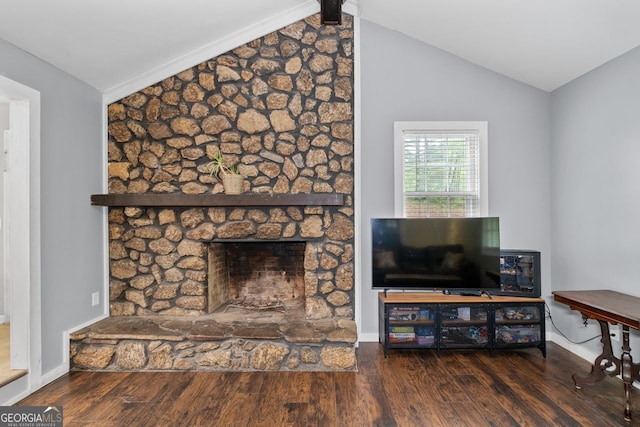 living area featuring vaulted ceiling and wood finished floors