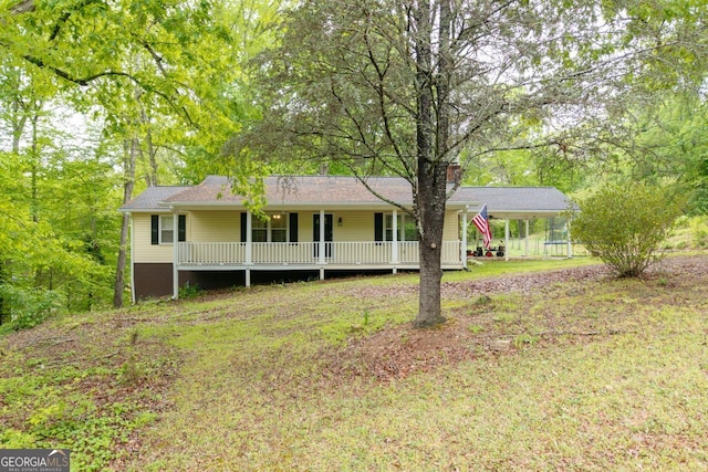 view of front facade with a porch and a carport
