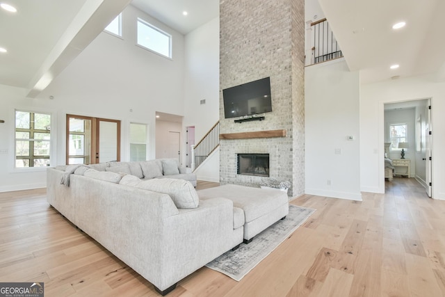 5315 Hendrix Rd, Cumming, GA 30040 - living room with plenty of natural light, baseboards, a towering ceiling, and light wood-type flooring