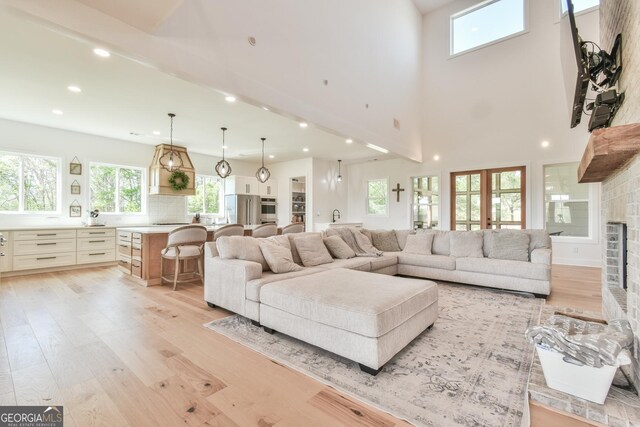 5315 Hendrix Rd, Cumming, GA 30040 - living area featuring light wood-style floors, recessed lighting, a brick fireplace, and plenty of natural light