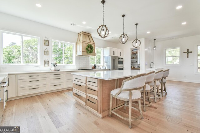 5315 Hendrix Rd, Cumming, GA 30040 - kitchen featuring recessed lighting, a large island, light wood-style flooring, and black electric stovetop