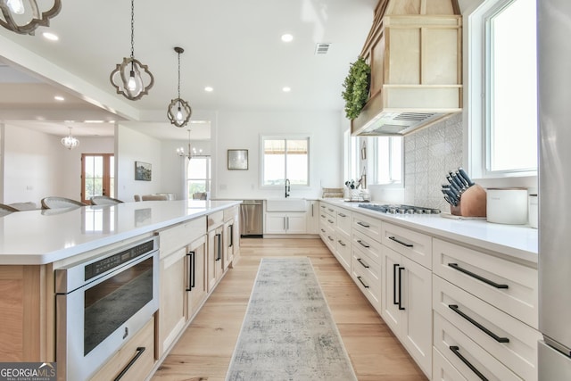 5315 Hendrix Rd, Cumming, GA 30040 - kitchen with a kitchen island, visible vents, appliances with stainless steel finishes, a sink, and custom range hood