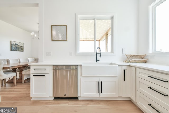 5315 Hendrix Rd, Cumming, GA 30040 - kitchen with stainless steel dishwasher, a chandelier, plenty of natural light, and a sink
