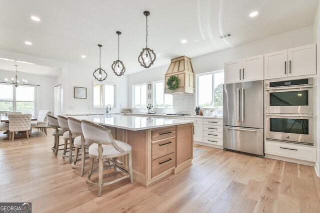 5315 Hendrix Rd, Cumming, GA 30040 - kitchen featuring visible vents, light countertops, an inviting chandelier, stainless steel appliances, and recessed lighting