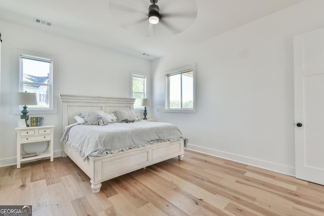 5315 Hendrix Rd, Cumming, GA 30040 - bedroom with light wood-style floors, baseboards, ceiling fan, and visible vents