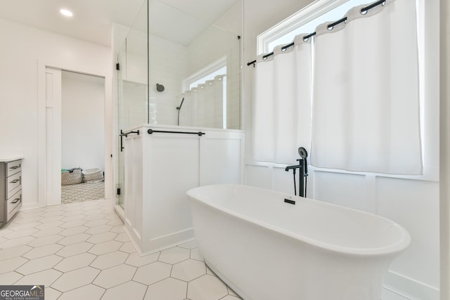 5315 Hendrix Rd, Cumming, GA 30040 - full bath with a freestanding tub, a shower stall, and baseboards