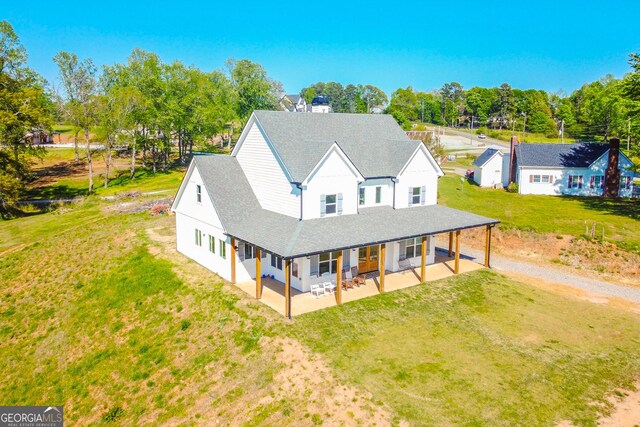 5315 Hendrix Rd, Cumming, GA 30040 - rear view of house with dirt driveway, a patio area, a yard, and a shingled roof