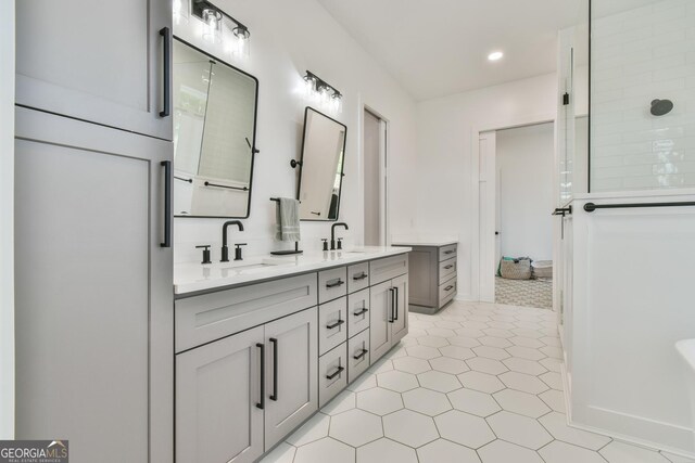 5315 Hendrix Rd, Cumming, GA 30040 - full bathroom with tile patterned flooring, double vanity, walk in shower, recessed lighting, and a sink