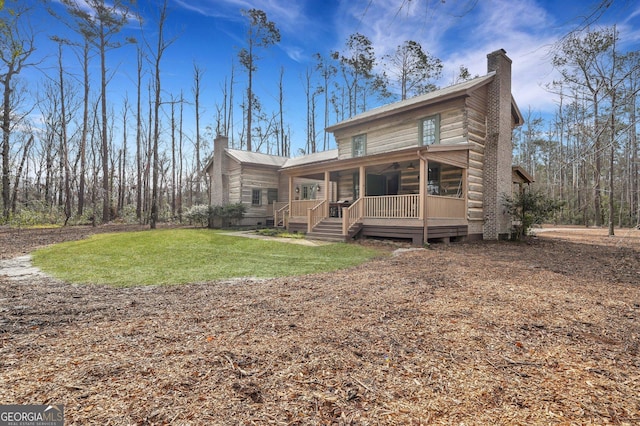590 Dogwood Way, Richmond Hill, GA 31324 - back of property with a chimney, a yard, and a porch