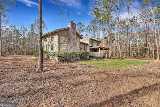 590 Dogwood Way, Richmond Hill, GA 31324 - view of property exterior featuring a chimney and a porch