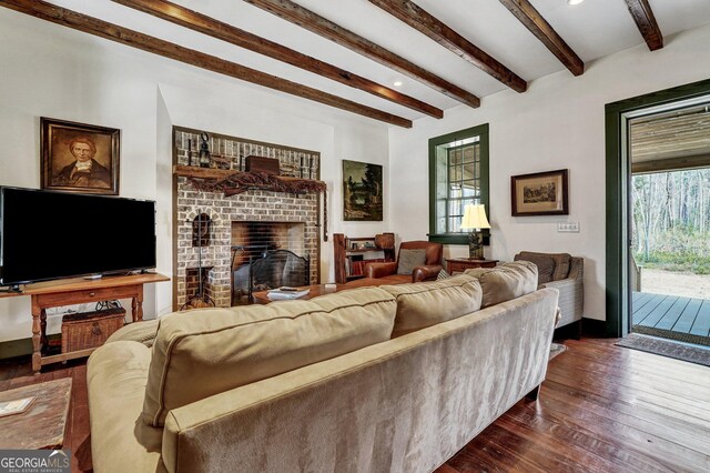 590 Dogwood Way, Richmond Hill, GA 31324 - living area featuring a brick fireplace, dark wood-style flooring, beam ceiling, and a wealth of natural light